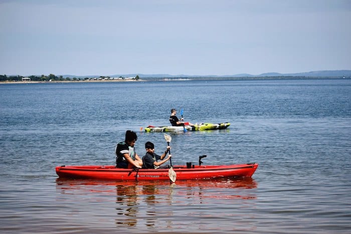 Image of guests canoeing on Lake Buchanan at our Texas cabin rentals in the Hill Country. Best family friendly cabin rentals in Texas are here at Cedar Lodge.