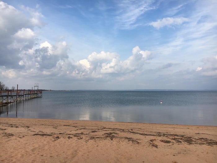 Image of our private sandy beach and fishing pier at Cedar Lodge. Our Hill Country Resort has the best cabin rentals in Texas and family friendly lake cabins in Texas. Best places for family reunions are here at Cedar Lodge.